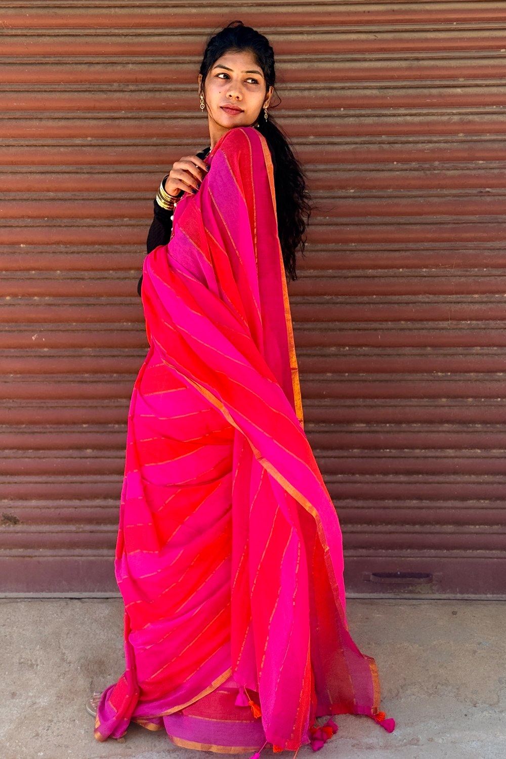 Rani pink to orange mul mul saree draped