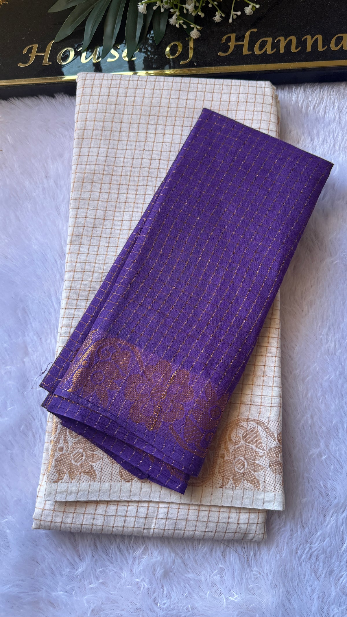 Purple Sungudi cotton saree folded to show the gold floral pallu
